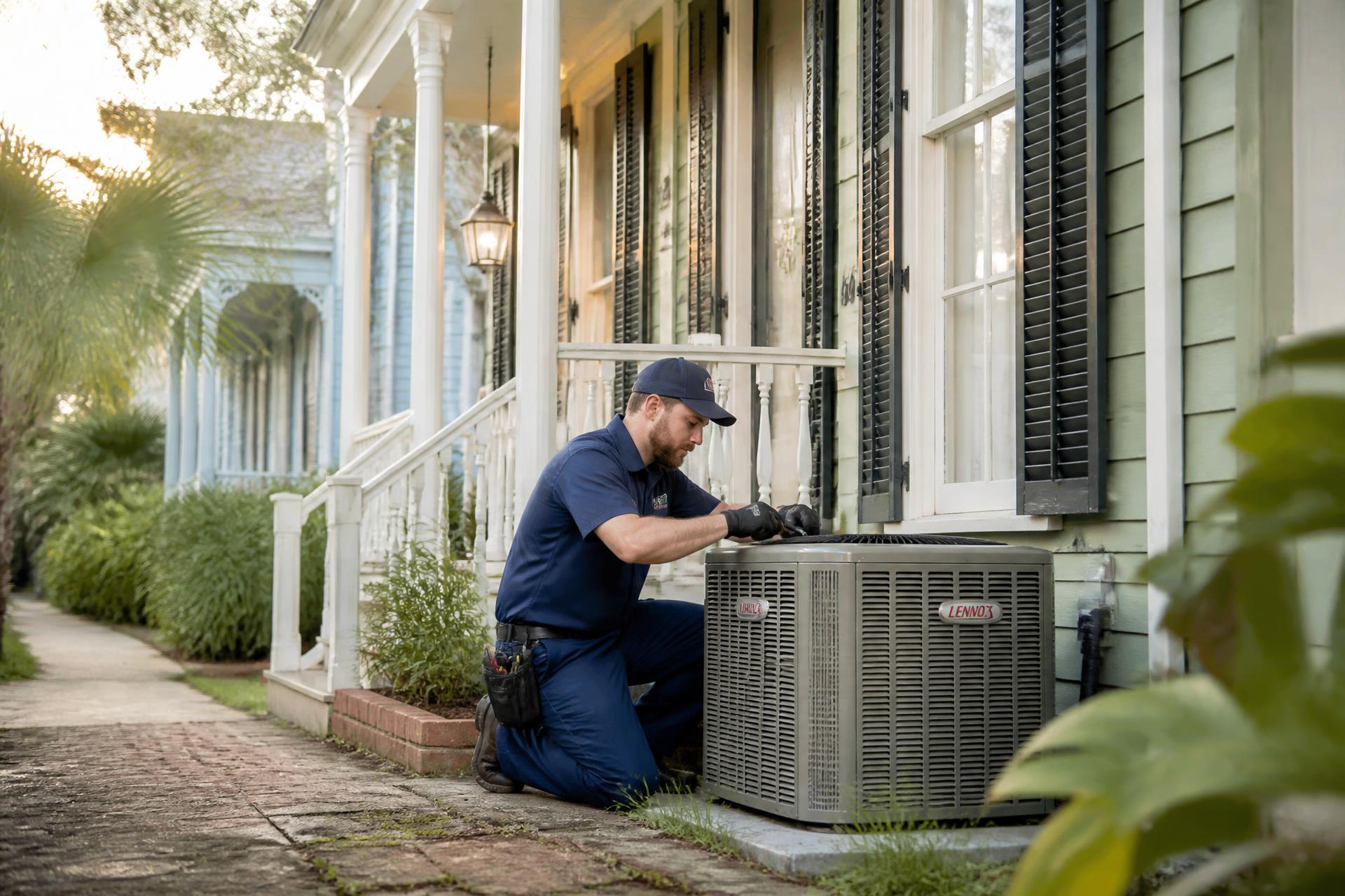 Duffyy's HVAC technician servicing an air conditioning condenser outside a New Orleans home